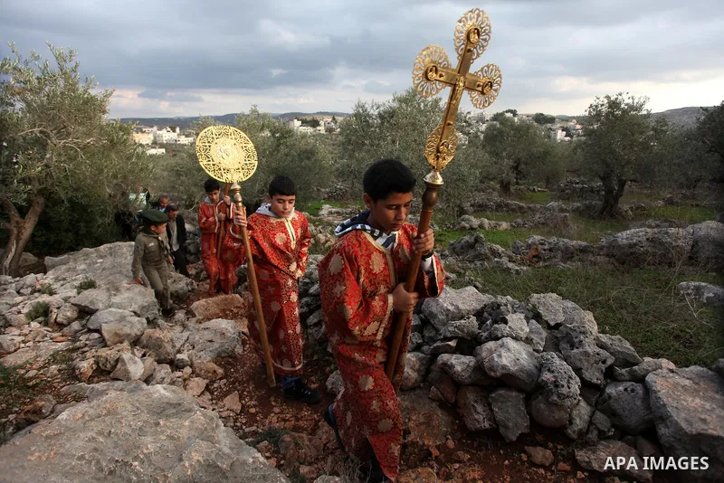 Palestinian Orthodox Christians return from the nearby ancient monastery of St. Barbara to the Palestinian village of Abud, in the Israeli occupied West Bank, during a parade to celebrate the annual festival of St. Barba...