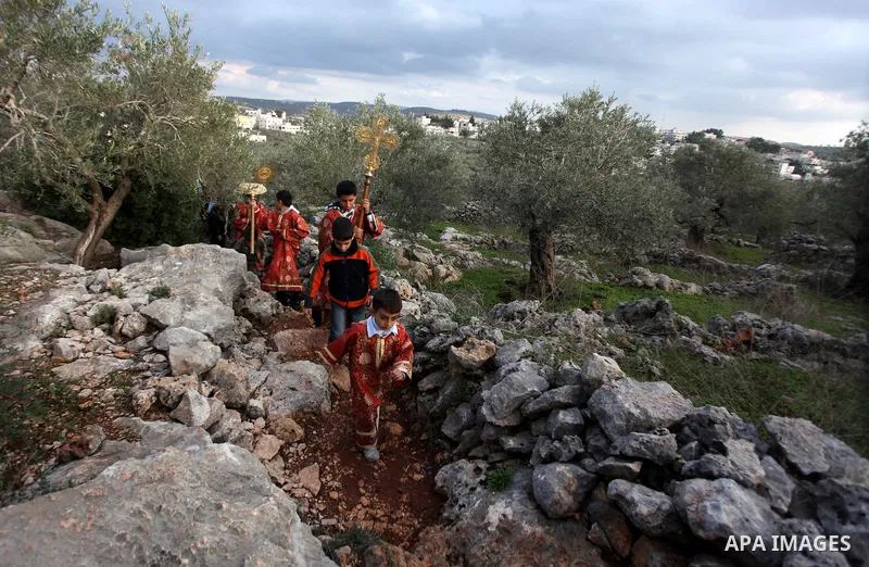 Palestinian Orthodox Christians return from the nearby ancient monastery of St. Barbara to the Palestinian village of Abud, in the Israeli occupied West Bank, during a parade to celebrate the annual festival of St. Barba...