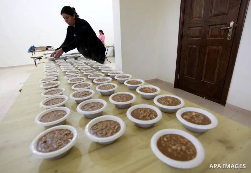 A Palestinian woman makes traditional sweets to mark the annual festival of St. Barbara's Day in the Palestinian village of Abud, in the Israeli occupied West Bank on December 16, 2012. Photo by Issam Rimawi