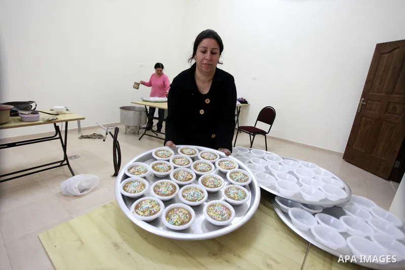 Palestinian women make traditional sweets to mark the annual festival of St. Barbara's Day in the Palestinian village of Abud, in the Israeli occupied West Bank on December 16, 2012. Photo by Issam Rimawi