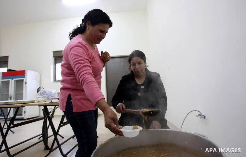 Palestinian women make traditional sweets to mark the annual festival of St. Barbara's Day in the Palestinian village of Abud, in the Israeli occupied West Bank on December 16, 2012. Photo by Issam Rimawi