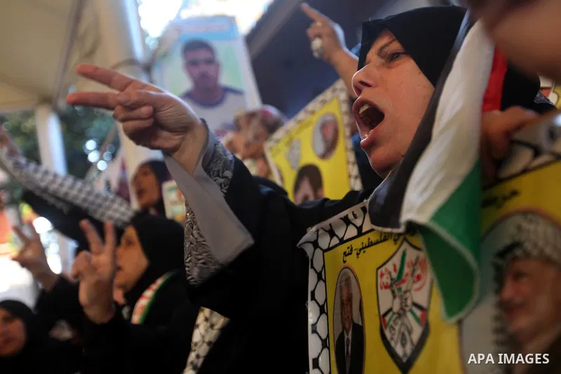 Palestinians hold pictures of their prisoner relatives in Israeli jails as they gather in a weekly activity calling for their liberty at the Red Cross headquarters in Gaza city on December 17, 2012. Photo by Majdi Fathi
