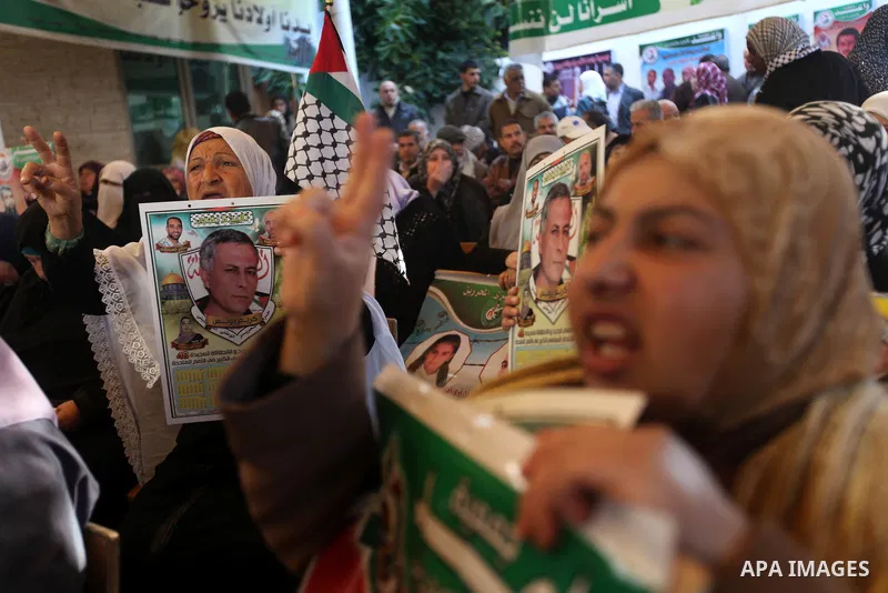 Palestinians hold pictures of their prisoner relatives in Israeli jails as they gather in a weekly activity calling for their liberty at the Red Cross headquarters in Gaza city on December 17, 2012. Photo by Majdi Fathi