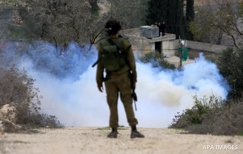 Israeli soldiers run during clashes between Jewish settlers and Palestinians, not seen, outside the West Bank village of Madama and the Jewish settlement of Yitzhar, near Nablus, Dec. 17, 2012. Photo by Nedal Eshtayah