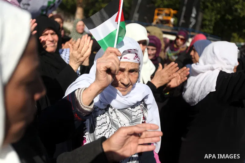 Palestinian women chant slogans during a protest calling for unity and to end the internal Palestinian division in Gaza City, Tuesday, Dec. 18, 2012. Arabic on the poster, left, reads," Palestine is above all," and at ri...