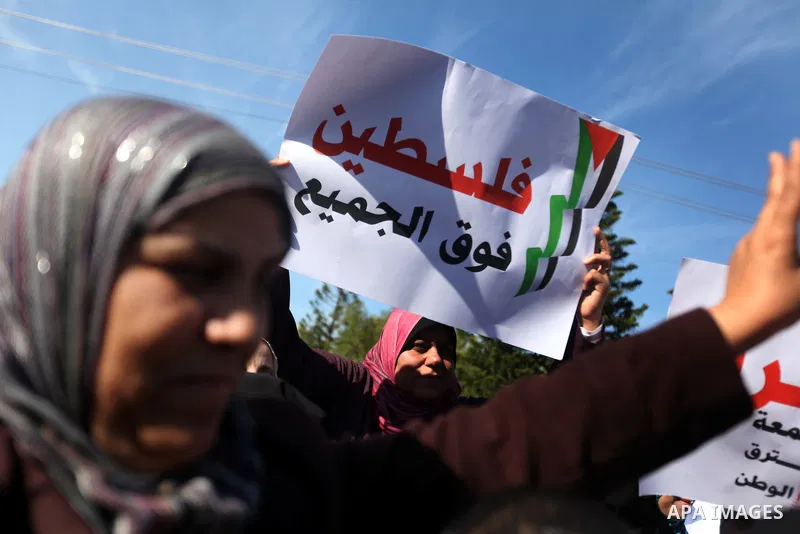 Palestinian women chant slogans during a protest calling for unity and to end the internal Palestinian division in Gaza City, Tuesday, Dec. 18, 2012. Arabic on the poster, left, reads," Palestine is above all," and at ri...
