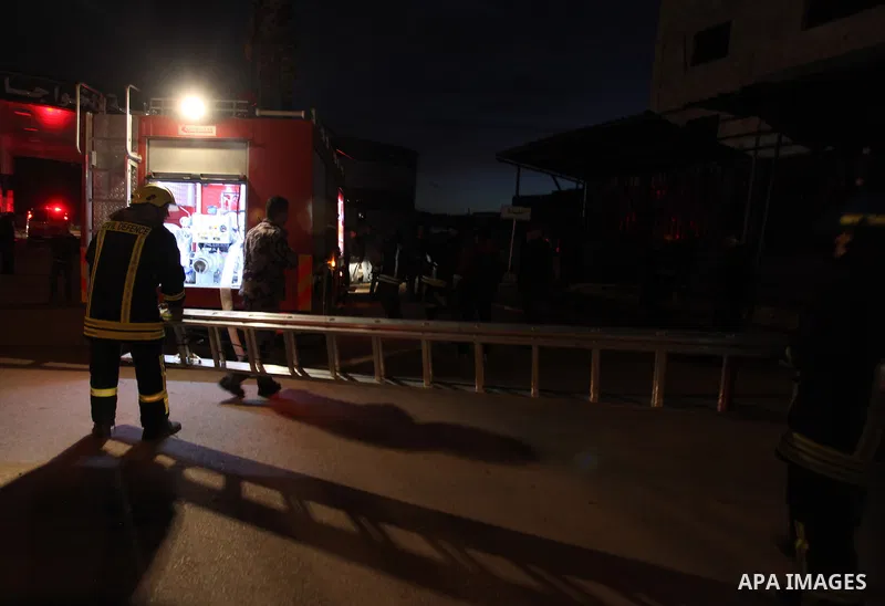 Palestinian firemen try to extinguish a fire after a fire broke out in a fuel tank at a filling station in Qalandia refugee camp near the West Bank city of Ramallah on 18 December 2012. Photo by Issam Rimawi