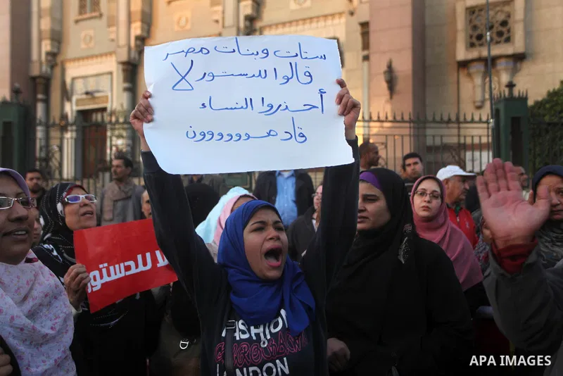 Egyptian protesters shout slogans against the President Mohamed Morsi and hold a banner reading in Arabic 'no to the constitution' during a demonstration against the draft constitution, in Cairo, Egypt, 18 December 2012....