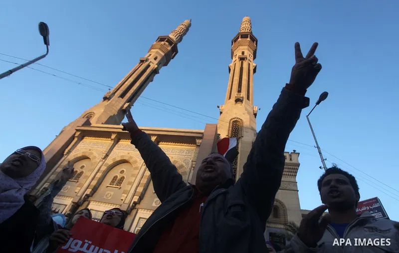 Egyptian protesters shout slogans against the President Mohamed Morsi and hold a banner reading in Arabic 'no to the constitution' during a demonstration against the draft constitution, in Cairo, Egypt, 18 December 2012....