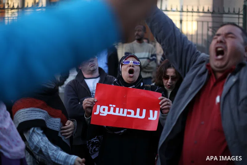 Egyptian protesters shout slogans against the President Mohamed Morsi and hold a banner reading in Arabic 'no to the constitution' during a demonstration against the draft constitution, in Cairo, Egypt, 18 December 2012....
