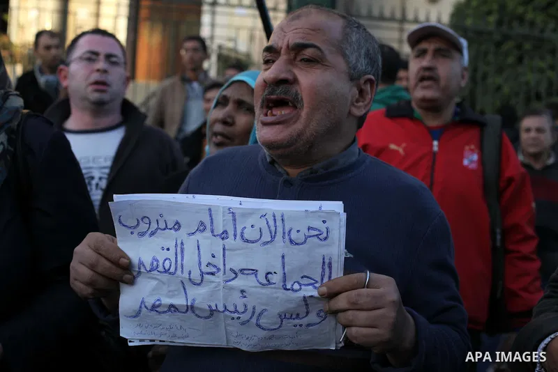 Egyptian protesters shout slogans against the President Mohamed Morsi and hold a banner reading in Arabic 'no to the constitution' during a demonstration against the draft constitution, in Cairo, Egypt, 18 December 2012....