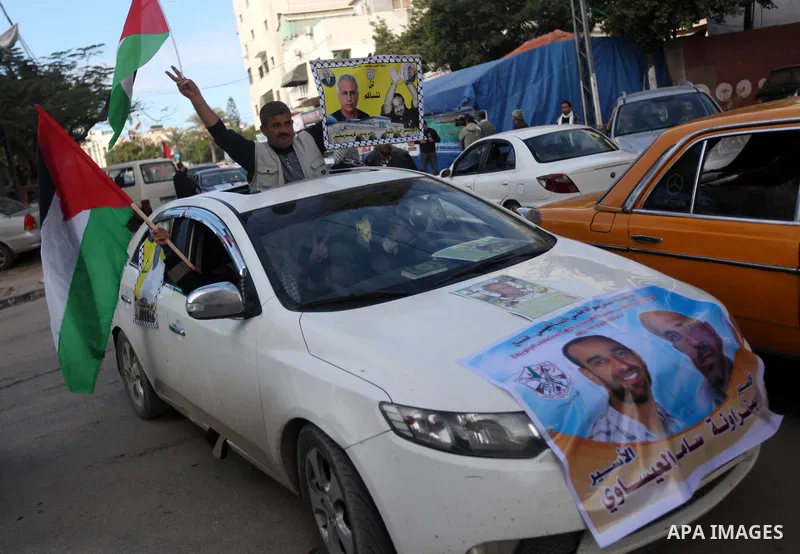 Palestinians hold pictures of prisoners held in the Israeli jails during a rally in Gaza city on December 19, 2012. in solidarity with hunger-striking detainees held by Israel to demand their release from detention witho...