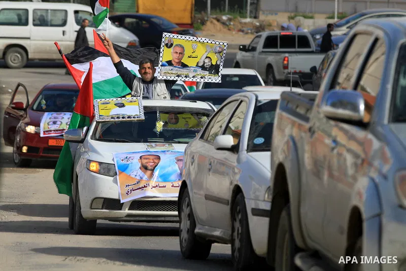 Palestinians hold pictures of prisoners held in the Israeli jails during a rally in Gaza city on December 19, 2012. in solidarity with hunger-striking detainees held by Israel to demand their release from detention witho...