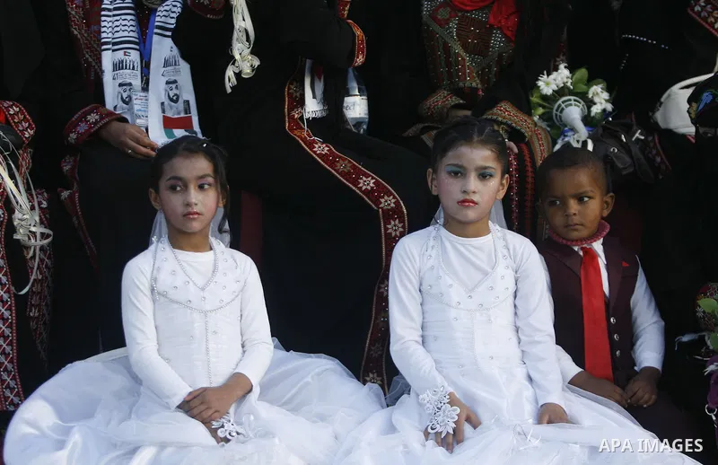 Palestinians attend a mass wedding ceremony in Rafah southern Gaza strip, on December 19, 2012. The mass wedding organized by National Islamic Committee and funding by the institution of Sheikh Khalifa bin Zayed bin Al N...
