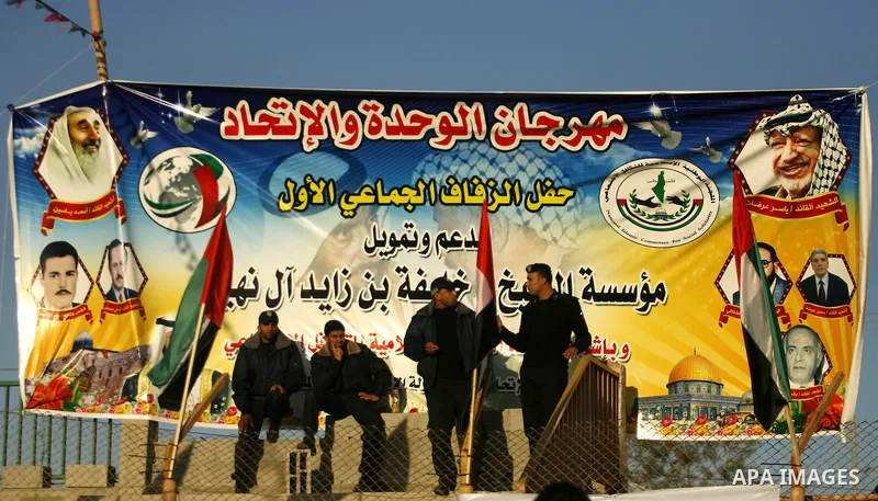 Palestinian policemen stand guard during a mass wedding ceremony in Rafah southern Gaza strip, on December 19, 2012. The mass wedding organized by National Islamic Committee and funding by the institution of Sheikh Khali...