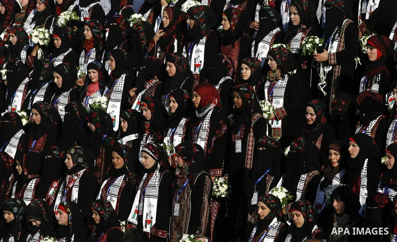 Palestinian brides pose during a mass wedding ceremony in Rafah southern Gaza strip, on December 19, 2012. The mass wedding organized by National Islamic Committee and funding by the institution of Sheikh Khalifa bin Zay...