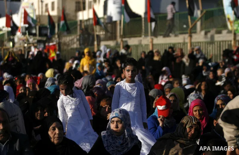 Palestinians attend a mass wedding ceremony in Rafah southern Gaza strip, on December 19, 2012. The mass wedding organized by National Islamic Committee and funding by the institution of Sheikh Khalifa bin Zayed bin Al N...