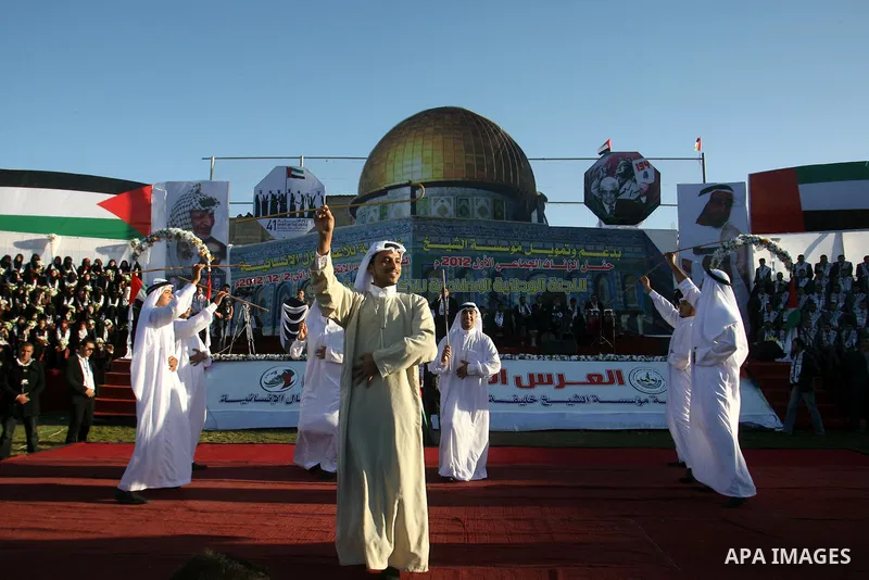 Palestinians perform traditional dance during a mass wedding ceremony in Rafah southern Gaza strip, on December 19, 2012. The mass wedding organized by National Islamic Committee and funding by the institution of Sheikh...