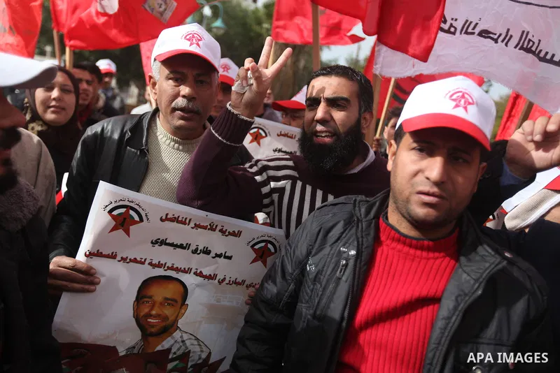 Supporters of the Popular Front for the Liberation of Palestine (PFLP) chant slogans during a demonstration in support of Palestinian prisoners held in Israeli jails, some of whom are observing a hunger strike, in Gaza c...