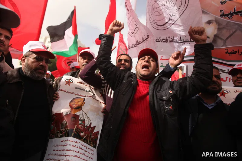 Supporters of the Popular Front for the Liberation of Palestine (PFLP) chant slogans during a demonstration in support of Palestinian prisoners held in Israeli jails, some of whom are observing a hunger strike, in Gaza c...