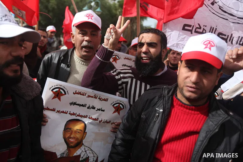 Supporters of the Popular Front for the Liberation of Palestine (PFLP) chant slogans during a demonstration in support of Palestinian prisoners held in Israeli jails, some of whom are observing a hunger strike, in Gaza c...