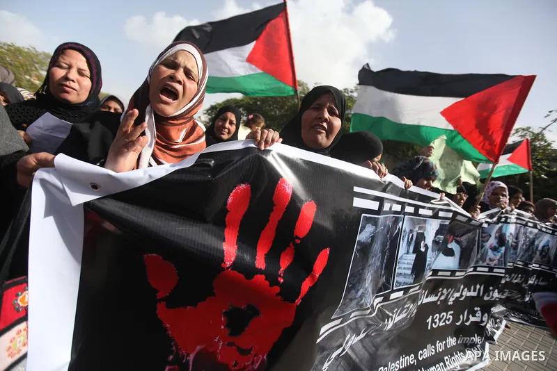 Palestinian women chant slogans during a protest calling for stop against women violence by Israeli forces in Gaza City, on Dec. 20, 2012. Photo by Majdi Fathi