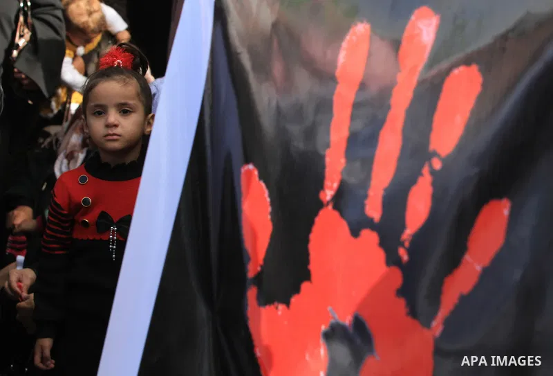 Palestinian women chant slogans during a protest calling for stop against women violence by Israeli forces in Gaza City, on Dec. 20, 2012. Photo by Majdi Fathi