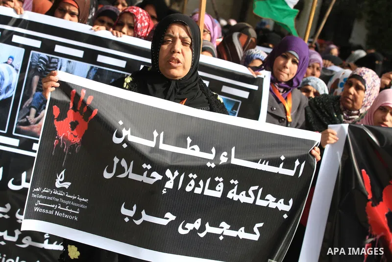 Palestinian women chant slogans during a protest calling for stop against women violence by Israeli forces in Gaza City, on Dec. 20, 2012. Photo by Majdi Fathi