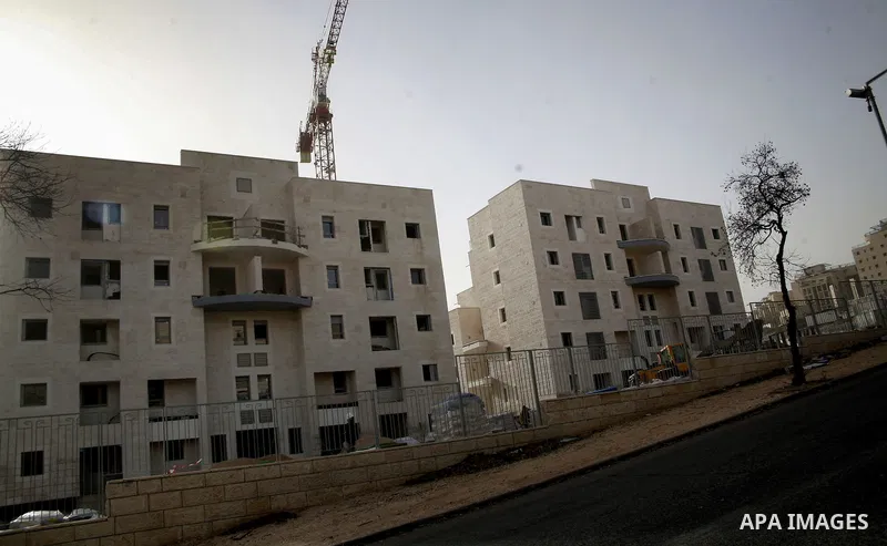 Labourers work at the construction site of a new housing project at the Jewish settlement of Kiryat Moreh in south Jerusalem on December 20, 2012. Israel has approved plans to build 523 homes in the West Bank, Jewish set...