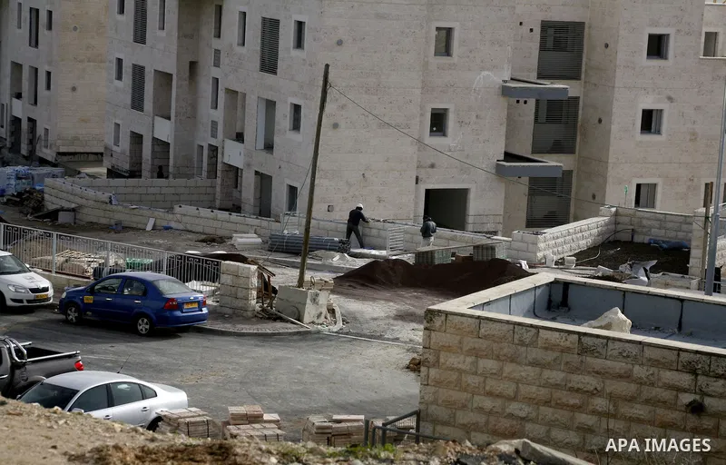 Labourers work at the construction site of a new housing project at the Jewish settlement of Kiryat Moreh in south Jerusalem on December 20, 2012. Israel has approved plans to build 523 homes in the West Bank, Jewish set...