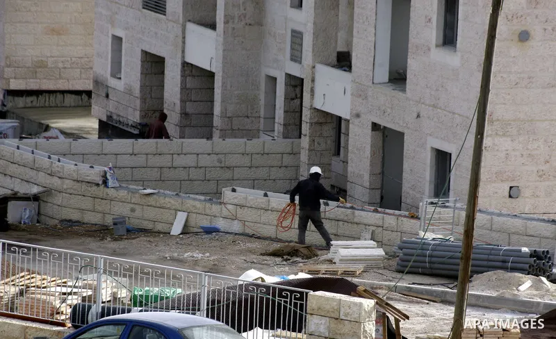 Labourers work at the construction site of a new housing project at the Jewish settlement of Kiryat Moreh in south Jerusalem on December 20, 2012. Israel has approved plans to build 523 homes in the West Bank, Jewish set...