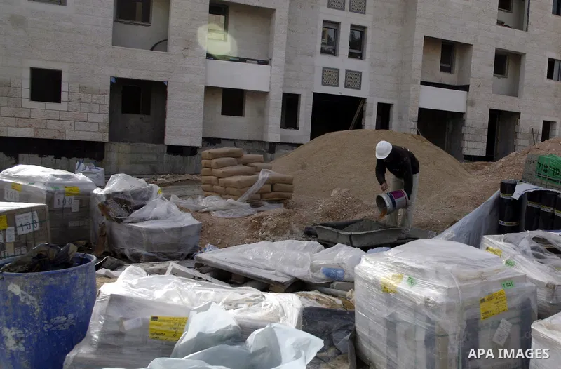 Labourers work at the construction site of a new housing project at the Jewish settlement of Kiryat Moreh in south Jerusalem on December 20, 2012. Israel has approved plans to build 523 homes in the West Bank, Jewish set...