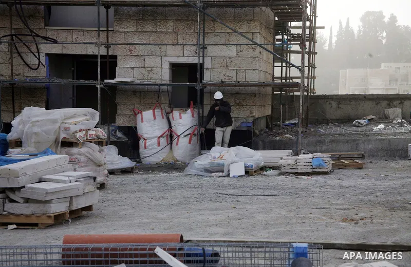 Labourers work at the construction site of a new housing project at the Jewish settlement of Kiryat Moreh in south Jerusalem on December 20, 2012. Israel has approved plans to build 523 homes in the West Bank, Jewish set...