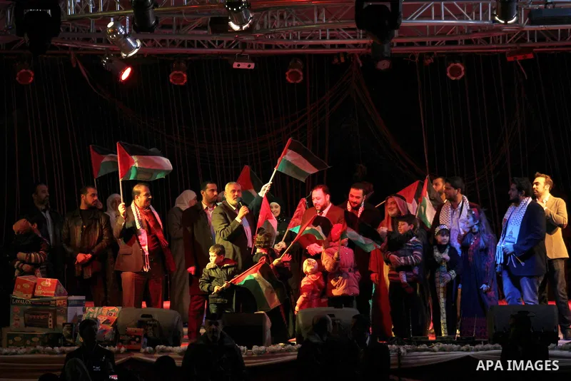 Palestinian Prime Minister in Gaza strip Ismail Haniyeh, Share with Members of the Birds of Paradise team sing during an Islamic song festival in Gaza City on December 20, 2012. Photo by Ezz Zanoun