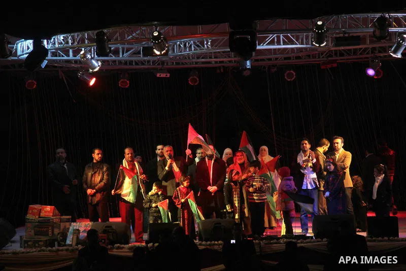 Palestinian Prime Minister in Gaza strip Ismail Haniyeh, Share with Members of the Birds of Paradise team sing during an Islamic song festival in Gaza City on December 20, 2012. Photo by Ezz Zanoun