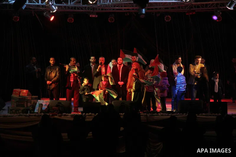 Palestinian Prime Minister in Gaza strip Ismail Haniyeh, Share with Members of the Birds of Paradise team sing during an Islamic song festival in Gaza City on December 20, 2012. Photo by Ezz Zanoun