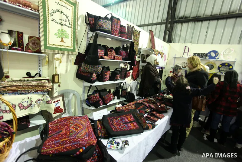 Palestinians attend the opening of the first winter shopping festival in the West Bank city of Ramallah, 21 December 2012. Photo by Issam Rimawi