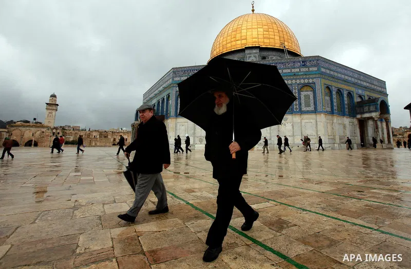 Palestinian worshippers walk in front of the Dome of the Rock mosque following Friday prayer at al-Aqsa mosque, Islam's third holiest site, in the old city of Jerusalem on December 21, 2012. Photo by Mahfouz Abu Turk