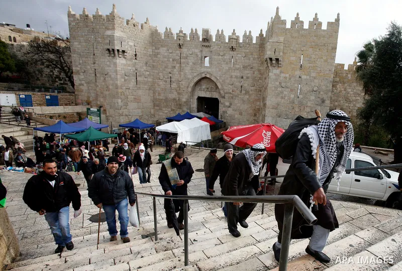 Palestinian worshippers walk in front of the Dome of the Rock mosque following Friday prayer at al-Aqsa mosque, Islam's third holiest site, in the old city of Jerusalem on December 21, 2012. Photo by Mahfouz Abu Turk
