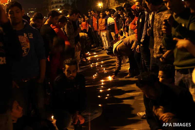 Egyptian protesters hold candles as they gather at Tahrir square in Cairo, Egypt, Friday, Dec. 21, 2012. Running clashes between rival protesters erupted in Egypt's second city Alexandria, on the eve of the final round o...