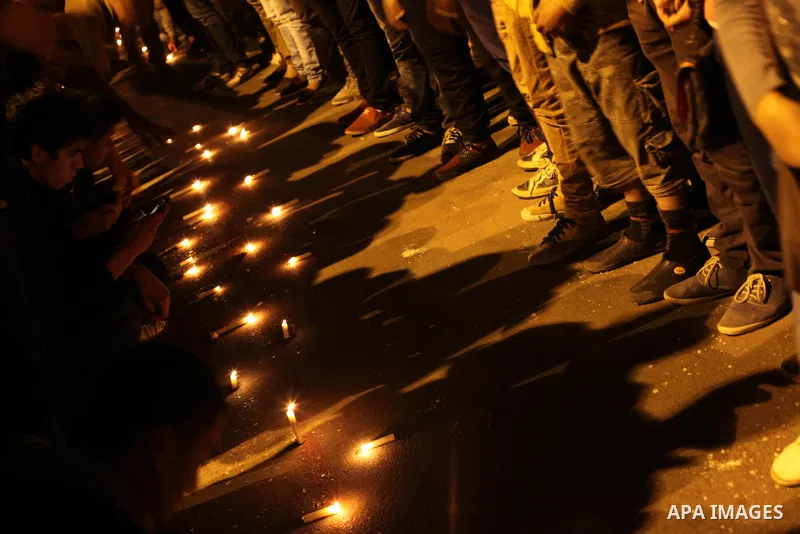 Egyptian protesters place candles as they gather at Tahrir square in Cairo, Egypt, Friday, Dec. 21, 2012. Running clashes between rival protesters erupted in Egypt's second city Alexandria, on the eve of the final round...
