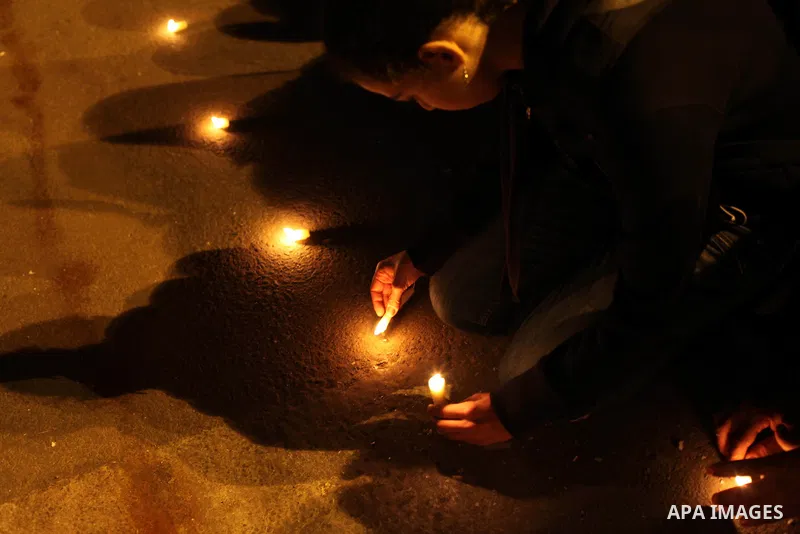 Egyptian protesters place candles as they gather at Tahrir square in Cairo, Egypt, Friday, Dec. 21, 2012. Running clashes between rival protesters erupted in Egypt's second city Alexandria, on the eve of the final round...