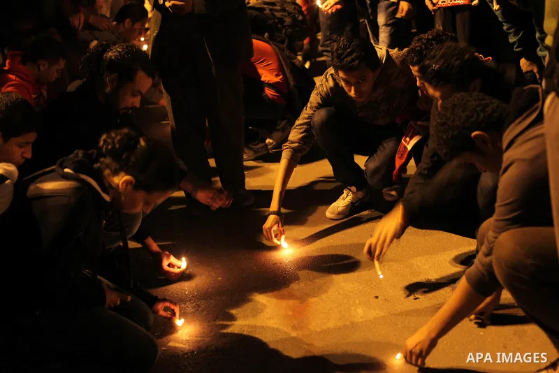 Egyptian protesters place candles as they gather at Tahrir square in Cairo, Egypt, Friday, Dec. 21, 2012. Running clashes between rival protesters erupted in Egypt's second city Alexandria, on the eve of the final round...