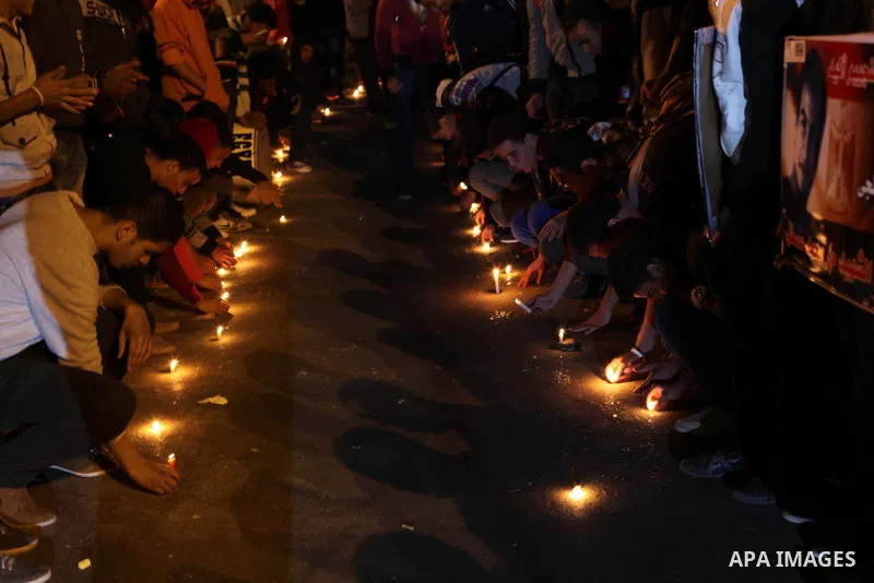 Egyptian protesters place candles as they gather at Tahrir square in Cairo, Egypt, Friday, Dec. 21, 2012. Running clashes between rival protesters erupted in Egypt's second city Alexandria, on the eve of the final round...