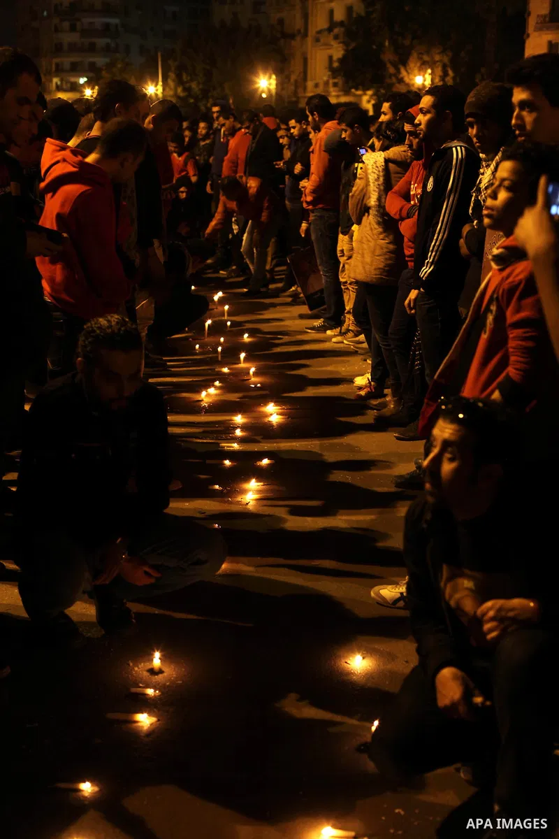 Egyptian protesters place candles as they gather at Tahrir square in Cairo, Egypt, Friday, Dec. 21, 2012. Running clashes between rival protesters erupted in Egypt's second city Alexandria, on the eve of the final round...
