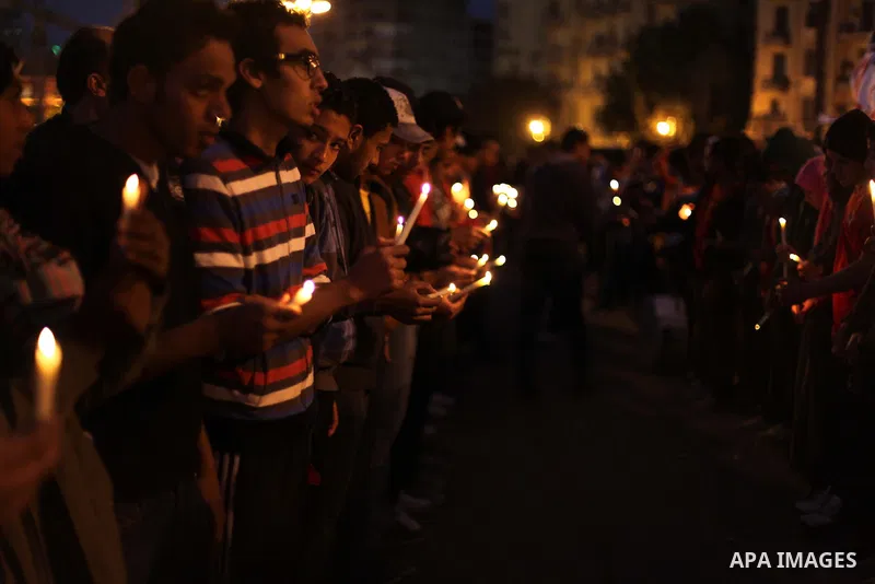 Egyptian protesters hold candles as they gather at Tahrir square in Cairo, Egypt, Friday, Dec. 21, 2012. Running clashes between rival protesters erupted in Egypt's second city Alexandria, on the eve of the final round o...