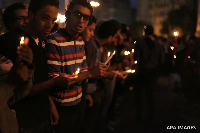 Egyptian protesters hold candles as they gather at Tahrir square in Cairo, Egypt, Friday, Dec. 21, 2012. Running clashes between rival protesters erupted in Egypt's second city Alexandria, on the eve of the final round o...
