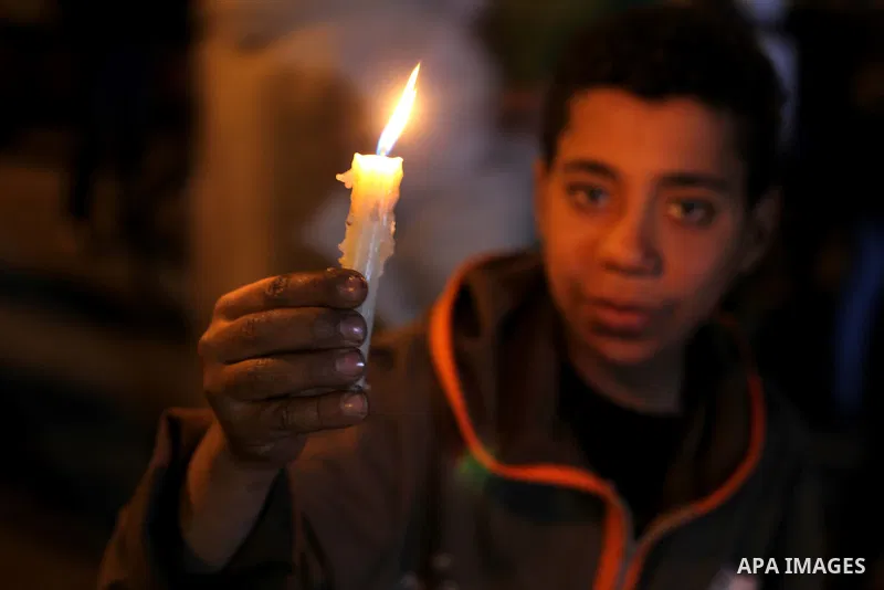 Egyptian protesters hold candles as they gather at Tahrir square in Cairo, Egypt, Friday, Dec. 21, 2012. Running clashes between rival protesters erupted in Egypt's second city Alexandria, on the eve of the final round o...
