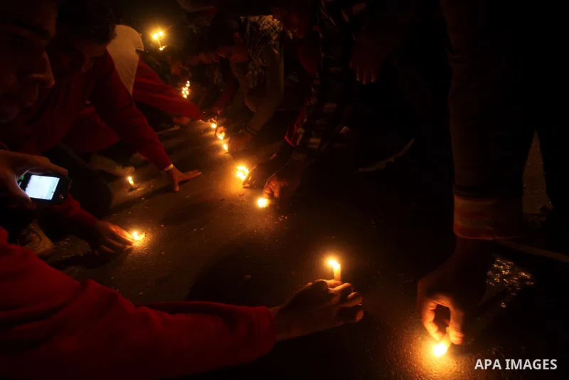 Egyptian protesters place candles as they gather at Tahrir square in Cairo, Egypt, Friday, Dec. 21, 2012. Running clashes between rival protesters erupted in Egypt's second city Alexandria, on the eve of the final round...