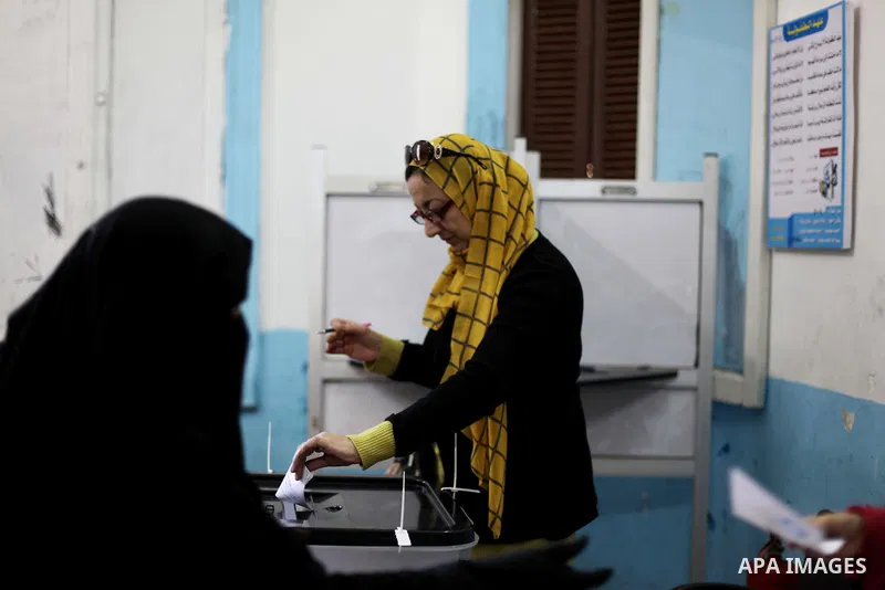 An Egyptian woman casts her ballot at a polling station during the second round of a referendum on a new draft constitution in Giza, south of Cairo, on December 22, 2012. Egyptians are voting in the final round of a refe...
